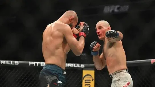 May 9, 2026; Newark, New Jersey, Khamzat Chimaev (red gloves) fights Sean Strickland (blue gloves) during UFC 328 at Prudential Center.